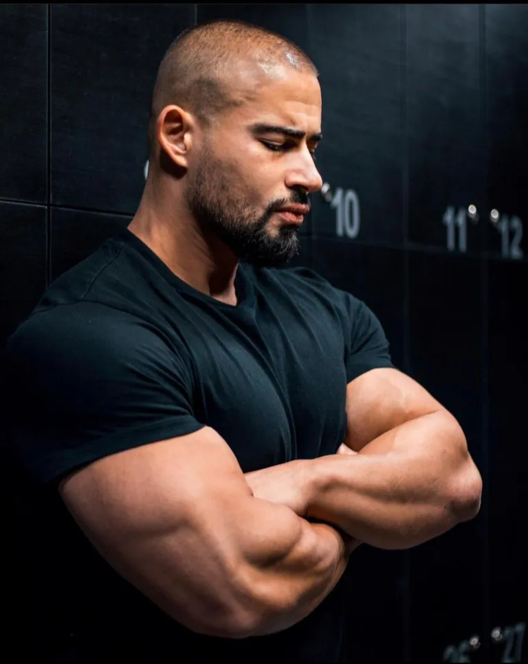 PK, head coach, arms crossed in the gym